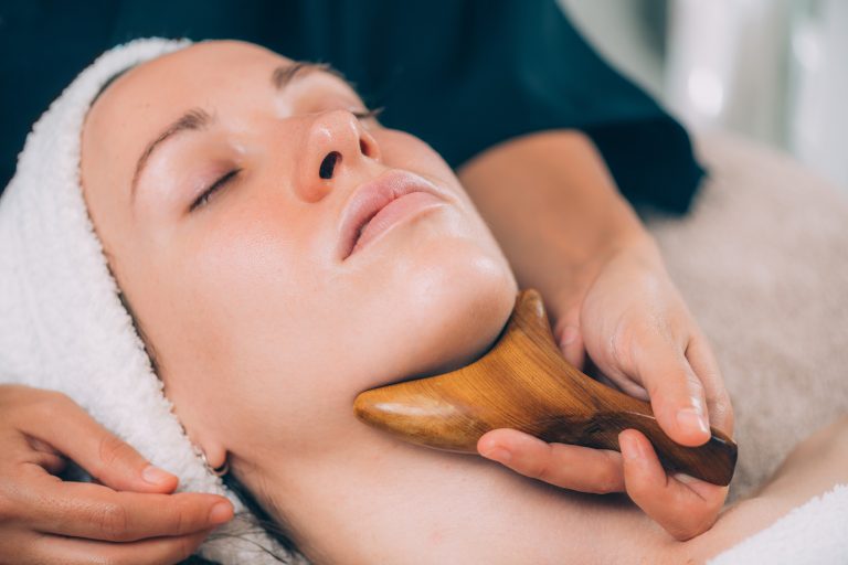 Lymphatic drainage face massage with wooden massager